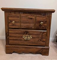 Front view of nightstand showing drawer configuration and hardware