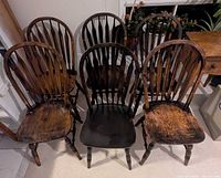 Front view of six wooden dining chairs showing overall style and finish