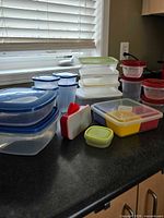 Group of assorted plastic containers on countertop