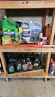 Overall shelving with coolant jug, motor oil, additives, scrub brush