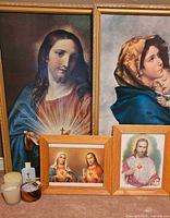 All framed prints with candles and holy water bottle