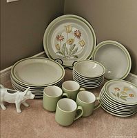 Stacked dinner and side plates, bowls, mugs, cow creamer