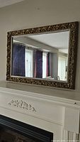 Front view of rectangular mirror mounted above mantel