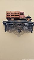 full view of wooden truck on carved shelf