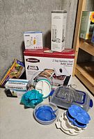 Group shot of all boxed appliances and assorted kitchenware on floor