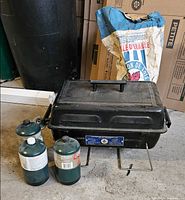 Front view of portable propane BBQ with two propane cylinders