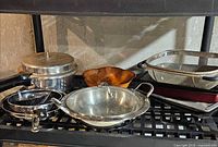 Overall lot showing pressure cooker, sauté pan, frying pan, roasting pan with mesh basket, steamer basket, wood bowl