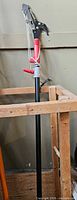 Full view of telescopic pole pruner showing pole, grip, rope and lopper head