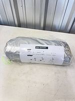 Rolled tent in clear carry bag showing side label