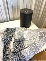 Trash can and folded shower curtain overview