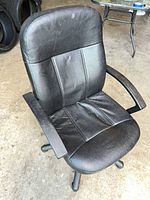 Front view of black faux leather office chair showing seat, backrest and armrests