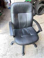 Front view of office chair showing seat, backrest, armrests, base