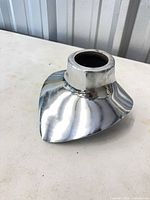 oblique front view showing polished finish and flared shape