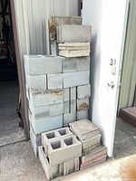 Stack of gray cinder blocks, pavers on top and bottom