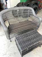 Dark brown wicker loveseat and matching storage bench shown together