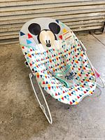 Front view of Disney Baby Mickey Mouse geometric bouncer seat showing fabric pattern and harness