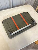 Top view of gray Fiskars paper trimmer with orange measurement guides