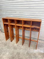 Front view of solid wood organizer showing five upper cubbies and five lower compartments