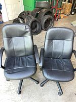 Front view of both black office chairs showing overall design and condition