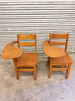 Front view of both wood chairs with integrated writing tablets