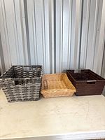 Front view of three baskets side by side showing colors and sizes