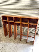 Front view showing full shelf structure with five top cubbies and four lower vertical compartments