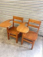 Front view of both wood chairs showing attached swivel tablets