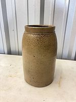 Front view of brown stoneware jar