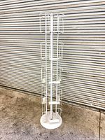 Full view of freestanding white wire postcard rack
