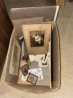 Cardboard box containing various mounted photographs, loose prints, small framed tintypes
