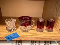 All four pressed glass pieces on shelf with size note