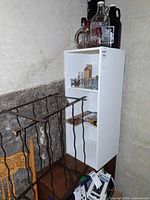 Overall lot showing wine rack, cabinet with glassware and bar tools, growler bottles on top