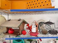 Shelf with wooden feeder, red hummingbird feeder parts, wire cylinder feeder, tube feeder and terra cotta house