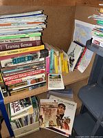 Wide view of shelves showing mixed stacks of travel books and maps