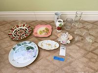 Group shot of all china plates, pitcher, vase, and etched glassware