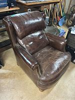 Front angled view of brown leather club chair
