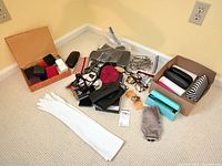 Entire lot spread on floor showing eyeglasses, cases, wallet, gloves, empty jewelry boxes