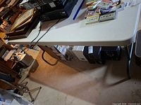 Overall view of Iceberg folding table with items on top and under