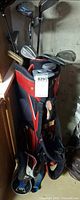 Full view of red/black golf bag with clubs