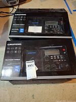 Two Grundig S450DLX radio boxes side by side