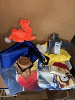 Group shot of oversized lighter and Joe Camel promotional items