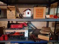 Shelf view shows transformer box, Whistle Station box and building, rail cars, wires, track connectors