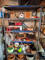 Full view of grey metal shelving with five shelves