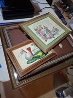 Stack of four framed needlework pieces