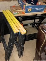 Saw horses stacked next to Workmate bench