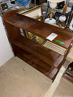 Full view of wooden shelf showing three tiers and condition