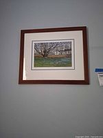 Front view of framed signed and numbered print on wall