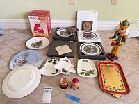 Group shot of all holiday plates, tray, pitcher, nutcracker, matryoshka and dishes