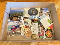 Box overview showing stamps, magnets, postcards and figurine