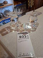 front view of two faceted crystal candle holders with spikes